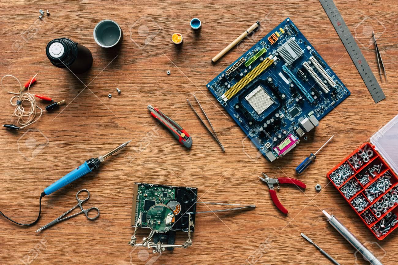 105705395-top-view-of-repairing-tools-motherboard-and-hard-drive-on-wooden-table.jpg