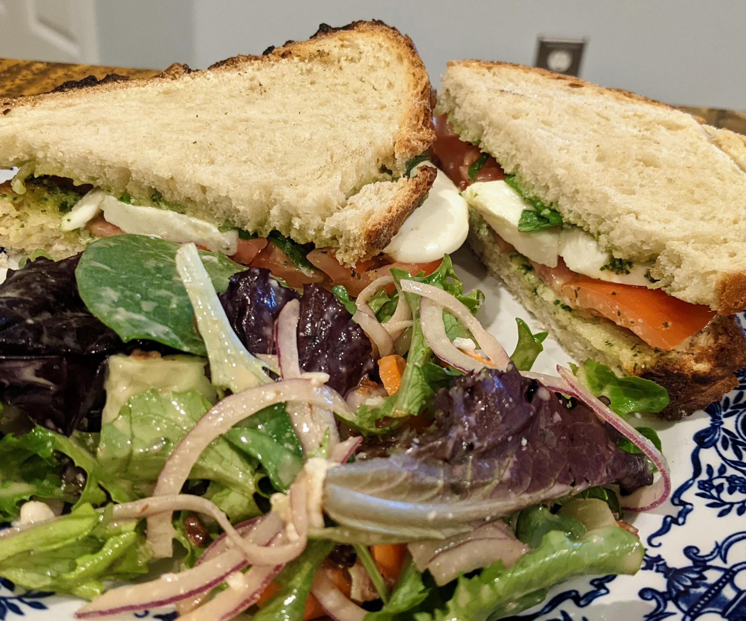 Pesto, Tomato, and Mozzarella Sandwich With Homemade Artisan Bread and a Refreshing Side Salad