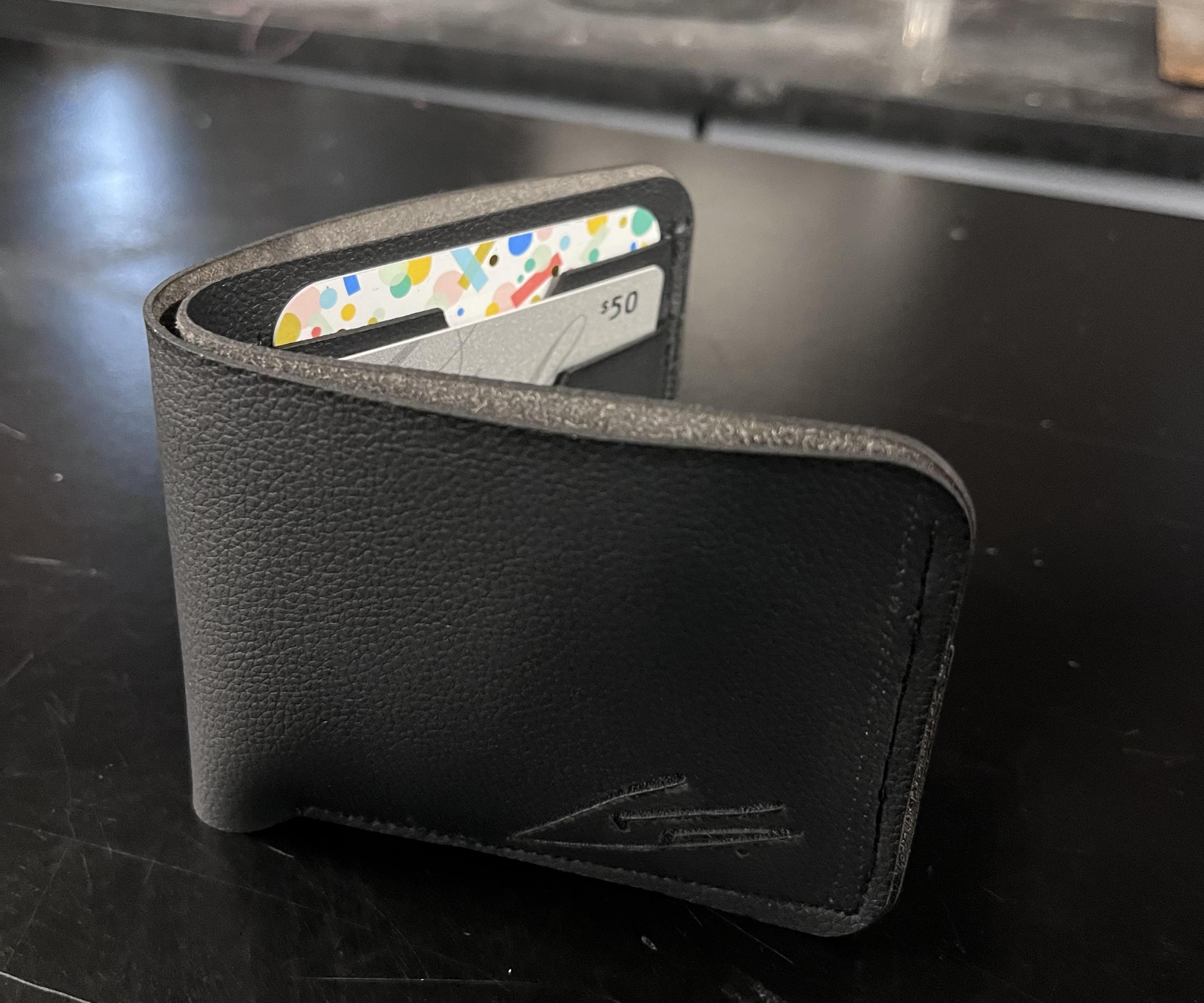 Real Leather Black Wallets With 4 Card Holders and Has a Logo on It