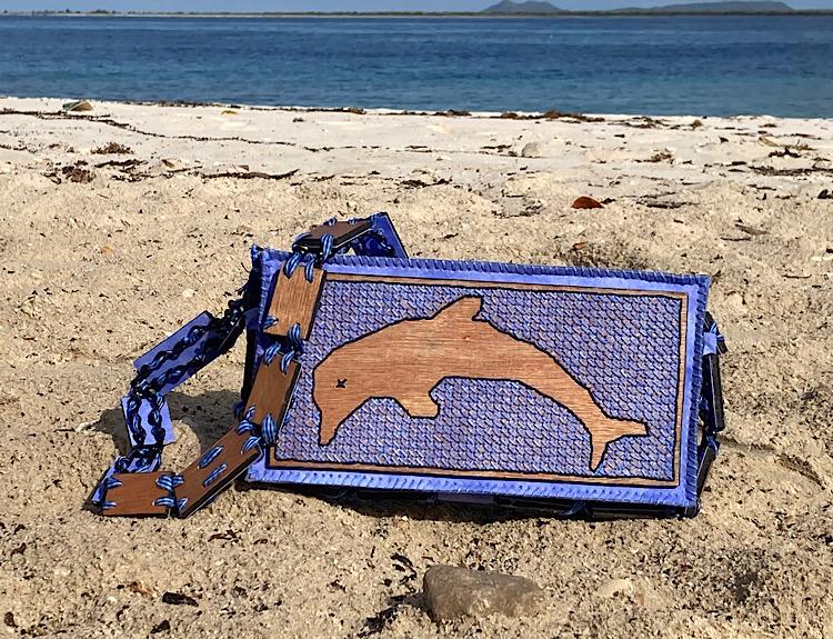 A Bag With a Dolphin in Cross Stitch on Plywood  